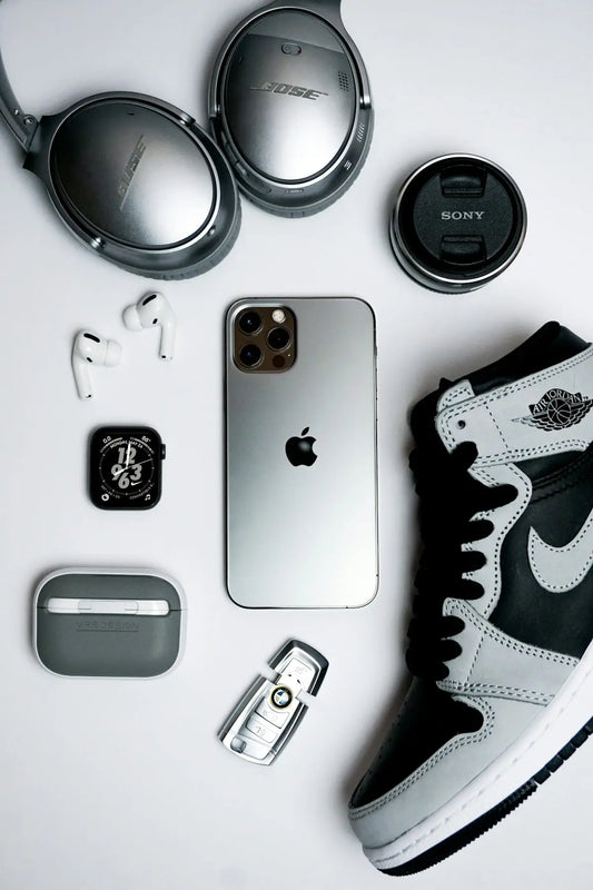 black iphone 4 beside silver and black camera